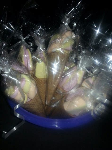 A Blue Bowl Filled With Ice Cream Cones And Wrapped In Plastic Wrapper On Top Of A Table