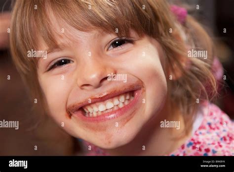 Girl Smiling With Chocolate Around Mouth Stock Photo Alamy