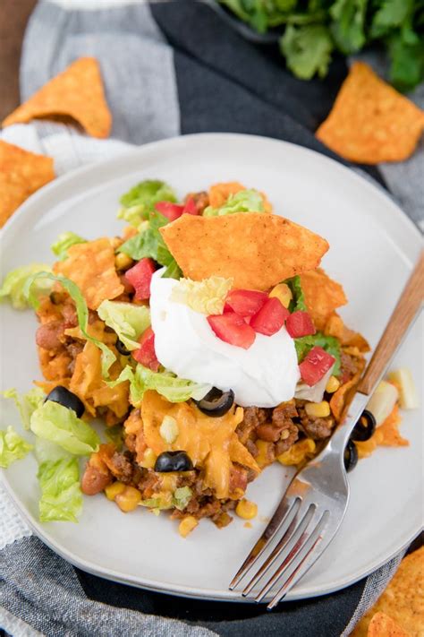 Begin by spreading the refried beans into the bottom of the casserole dish. Dorito Taco Salad Casserole | Easy and Delicious ...