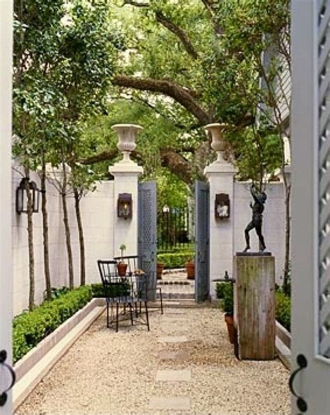 The side courtyard, with stepping stones and dichondra grass, surrounds a focal crape myrtle tree. Gas Lanterns & courtyard idea for side if house leading to ...