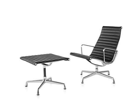 A eames aluminum group for herman miller lounge chair & ottoman in black leather, with grey fabric head cushion. Eames Aluminum Group Lounge Chair and Ottoman - Herman Miller