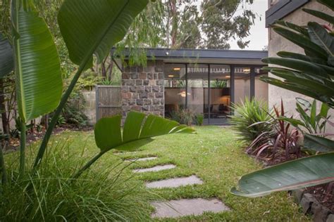The front door was under a large (15 x 40 foot) trellis infilled with corrugated plastic sheeting covering an exposed aggregate patio. Mid Century Modern Garden Design Photograph | Beaumaris mid