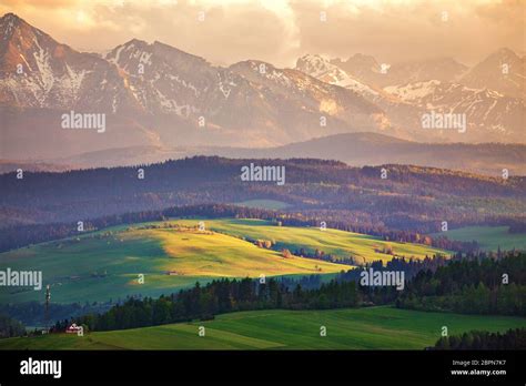 Snow Caped Mountains And Green Fields And Meadows In Malopolska Region