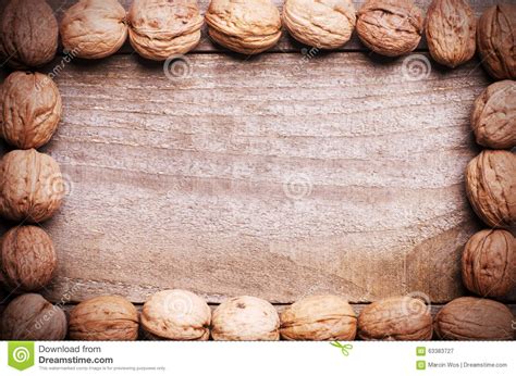 Simple Frame Arranged From Walnuts On Wooden Background Stock Image