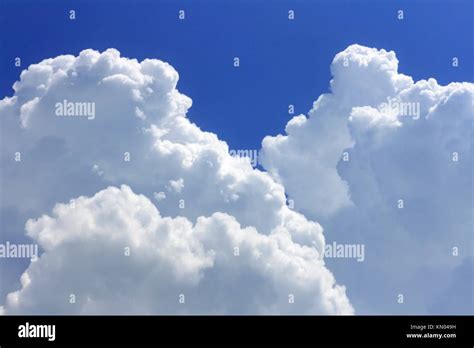 Fluffy White Cumulus Clouds Over A Blue Sky Stock Photo Alamy