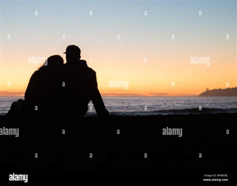 Silhouette Couple On Beach Sitting Hi Res Stock Photography And Images