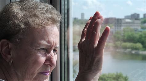Old Sad Woman Looking Out The Window The Concept Of Old Age And