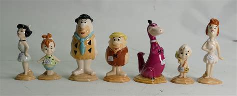 A Collection Of Beswick Flintstones Figures Fred And Wilma Pebbles