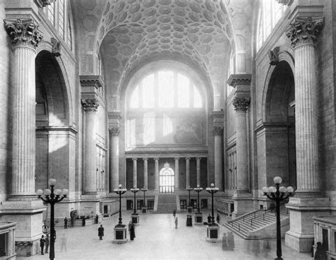 An Old Black And White Photo Of The Inside Of A Building With Columns