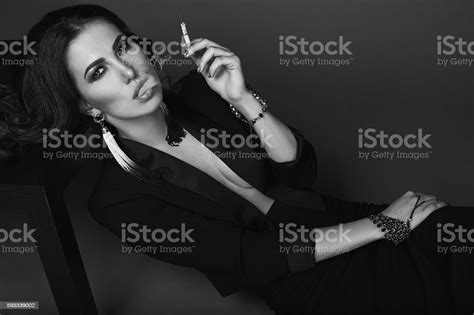Elegant Hot Brunette Woman Smoking A Cigarette Stock Photo Download