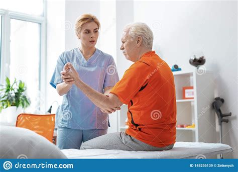 Pleasant Nice Elderly Man Having Hand Massage Stock Image Image Of Generation Room 148256139