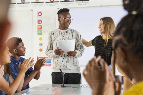 High School Students Clapping For Classmate In Debate Class Stock Photo