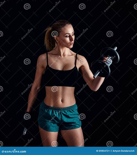 Portrait Of A Young Fitness Woman In Sportswear Doing Workout With
