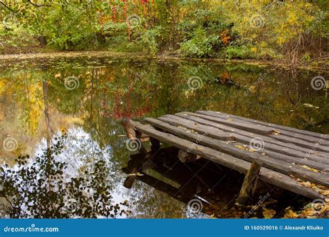 A Small Wooden Pier On A Quiet Lake On An Autumn Day Autumnal Colorful