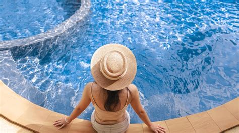 Jovem mulher bonita asiática relaxando na piscina do spa resort lindo resort de hotel em frente