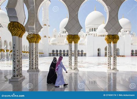 muslim man and woman walking at sheikh zayed grand mosque taken on march 31 2013 in abu dhabi