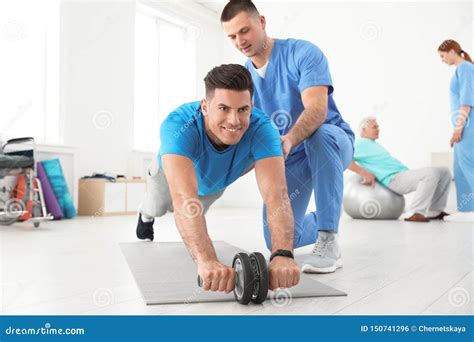 Professional Physiotherapist Working With Male Patient Stock Photo