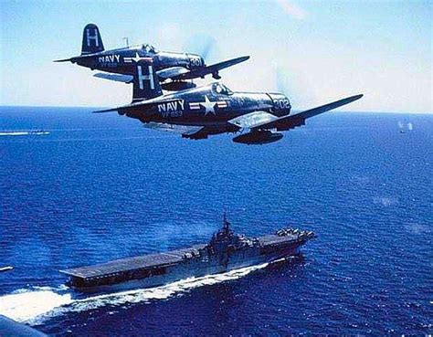 A Pair Of Chance Vought F4u Corsairs Overfly A Carrier Fighter
