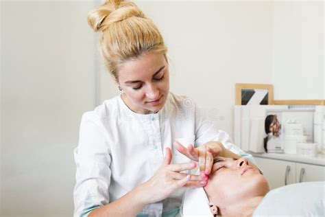 Female Beautician Doing Facial Massage Her Female Client In A Beauty