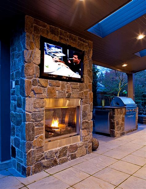 Double Sided Fireplace With Wall Mounted Television In The Patio Decoist