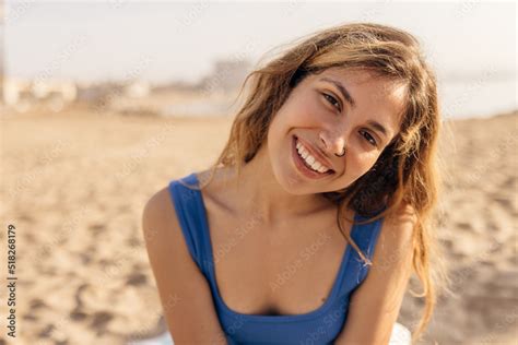 Cute European Young Lady Smiles Teeth Looking At Camera Relaxing On