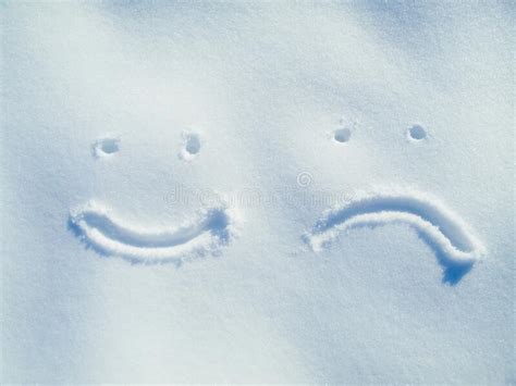 The Faces Of Winter Smiley And Frowny Faces In The Snow Stock Image