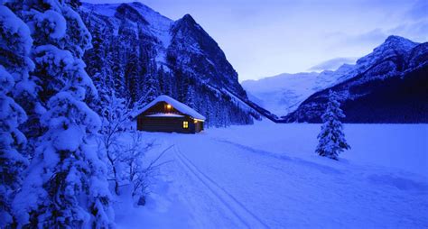 Download Scenic Cozy Winter Cabin Surrounded By Snowy Landscape