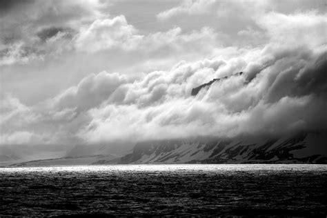 Black And White Cliff Beside Backlit Ocean Nick Dale Private Tutor