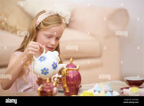 Having The Perfect Tea Party A Cute Little Girl Playing At Having A