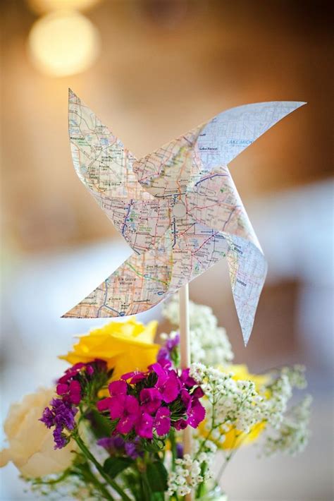 Centerpiece With Flowers And Map Pinwheel Centerpieces Dream Wedding Wedding Planning