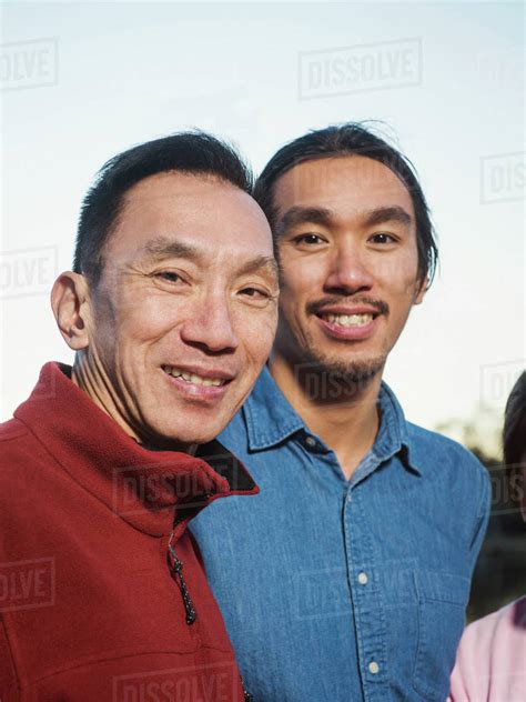 Chinese Father And Son Smiling Outdoors Stock Photo Dissolve