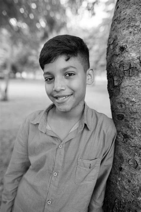 Portrait Of Young Indian Boy Relaxing At The Park Stock Photo Image