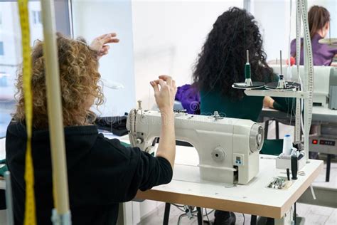 Young Tailors Sew Clothes On Sewing Machine In Atelier Studio Stock