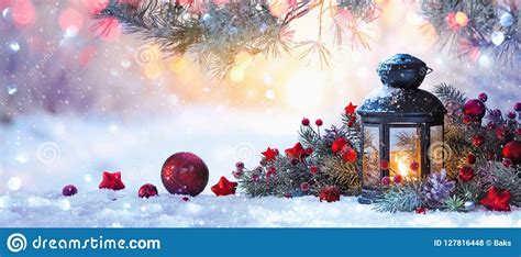 Christmas Lantern On Snow With Fir Branch In The Sunlight Stock Photo