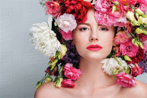 Portrait Of Gorgeous Naked Woman With Beautiful Flowers On Head Looking At Camera Isolated On