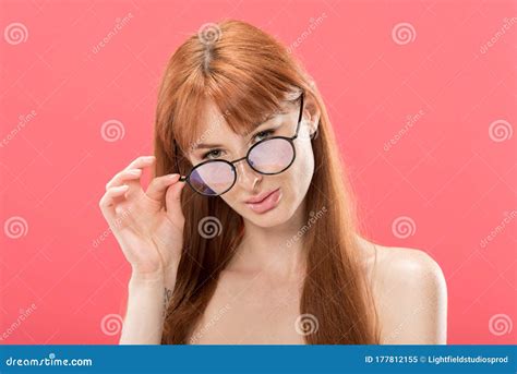 Curious Redhead Woman Looking At Camera And Touching Glasses Isolated