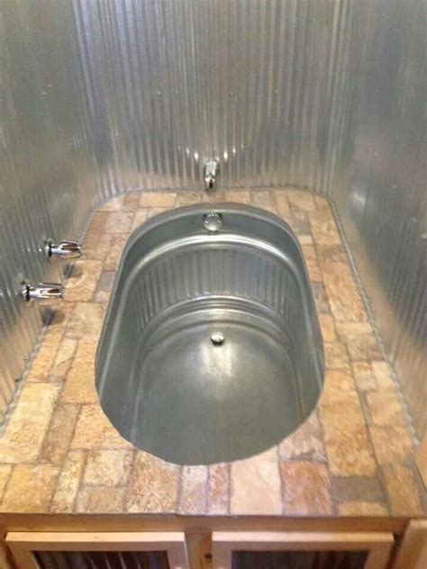 If you have been looking for a good hot tub but have been turned off by the cost, a stock tank soaking tub might be just the solution for you! Stock Tank Shower/Tub | The Building Code Forum