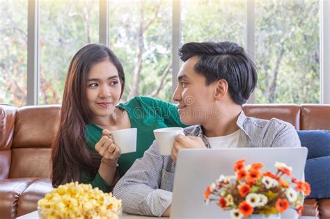 Man And Woman Drinking Coffee In Living Room Stock Image Image Of