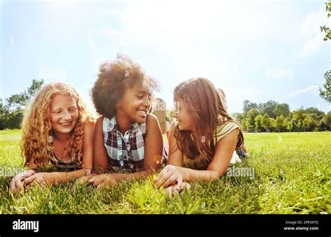 Im So Happy To Call You My Best Friends Three Young Girls Lying Together On The Grass Outside