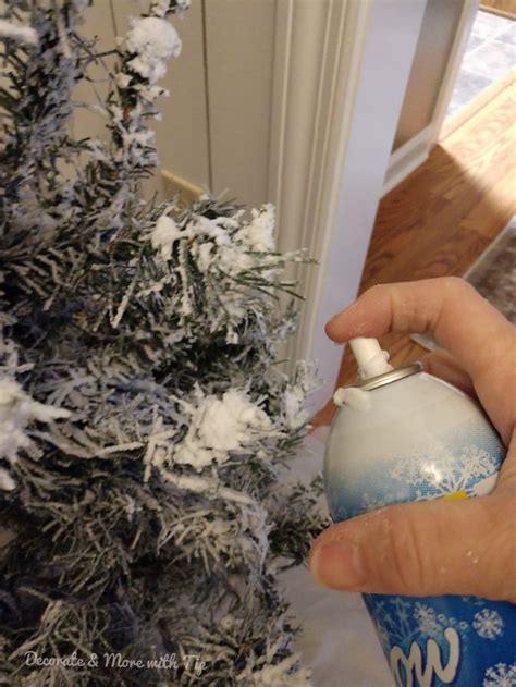 Someone Is Decorating A Christmas Tree With Spray Paint