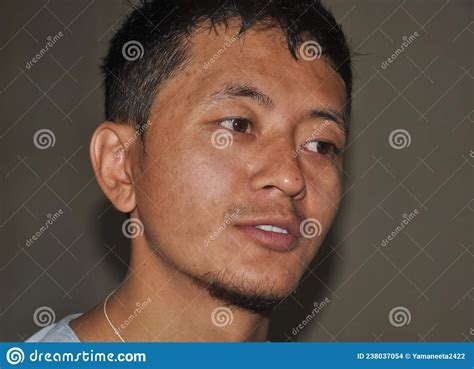 Closeup Shot Of A Asian Guy Face With Looking Sideways Stock Photo