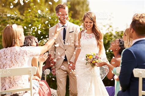 Our ambition is to alter the perception of wedding photography with a unique approach to the traditional package. Guests Throwing Confetti Over Bride And Groom At Wedding Stock Photo - Download Image Now - iStock