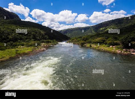 River Water Flowing Downstream Through Summer Tropical Valley Landscape