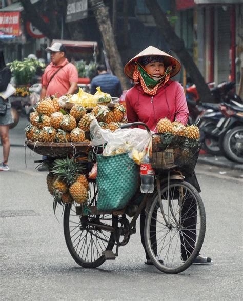 a vietnamese woman selling pineapples on the street 🍍 vietnam hanoi hanoivietnam
