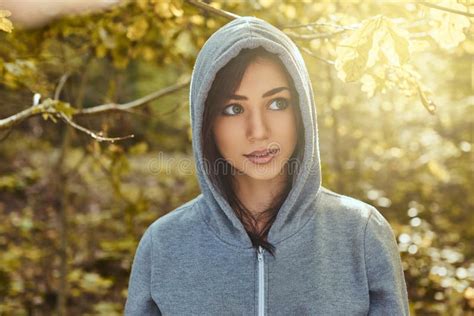 A Charming Girl Wearing A Gray Hoodie In The Autumn Park Stock Image
