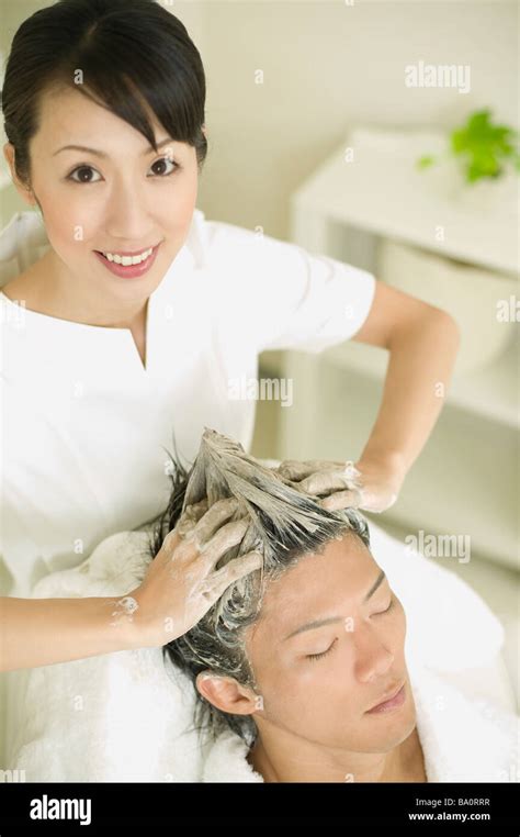 Massage Therapist Applying Hair Restoration Massage Stock Photo Alamy