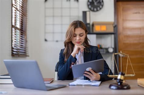 Attractive Young Lawyer In Office Business Woman And Lawyers Discussing