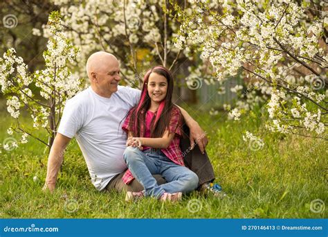 happy granddaughter hugging her smiling grandfather on green lawn stock image image of