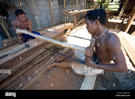 Filipino Laborers Team Saw A Bulk Piece Of Narra Wood Into Planks In