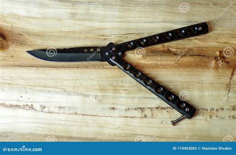 Butterfly Knife On A Wooden Background Black Knife Butterfly Balisong
